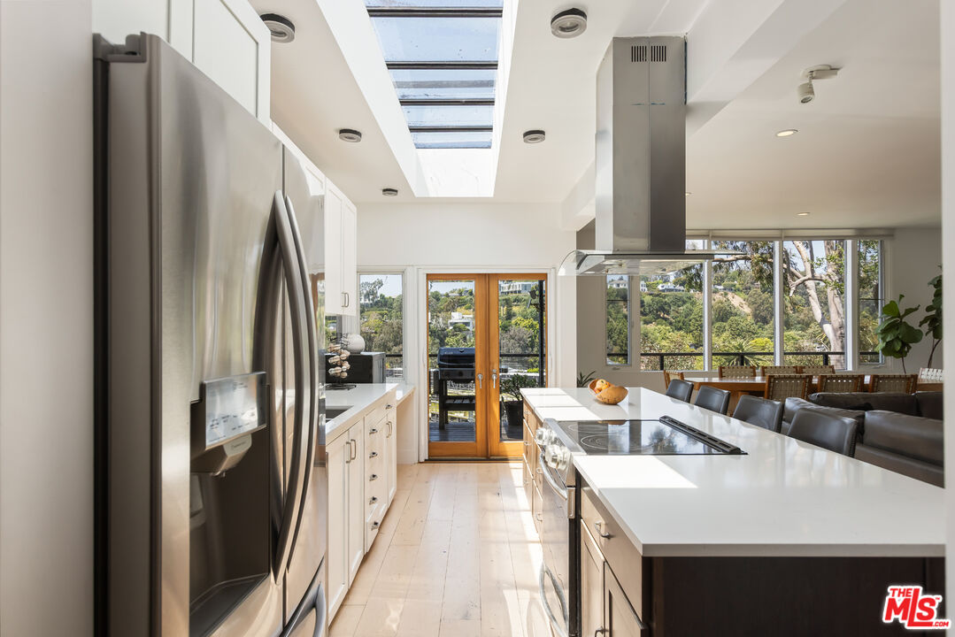 454 Stassi Lane Santa Monica, CA 90402 - Photo 6 of 33 a kitchen with stainless steel appliances granite countertop a refrigerator a sink and a stove