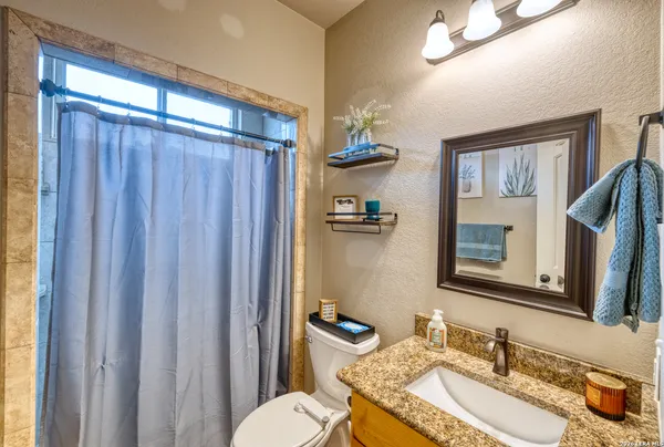 a bedroom with bed and a large window