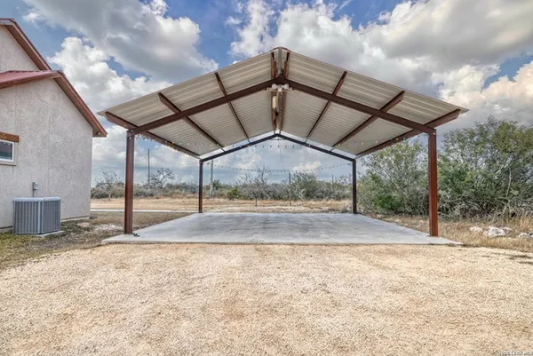 an aerial view of a house with a yard and lake view