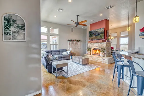 a living room with dining table and a chandelier