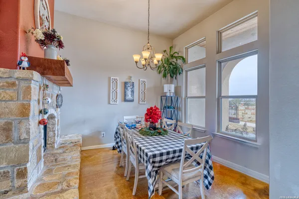 a view of a dining room with furniture and a chandelier