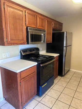 a kitchen with a stove microwave and refrigerator