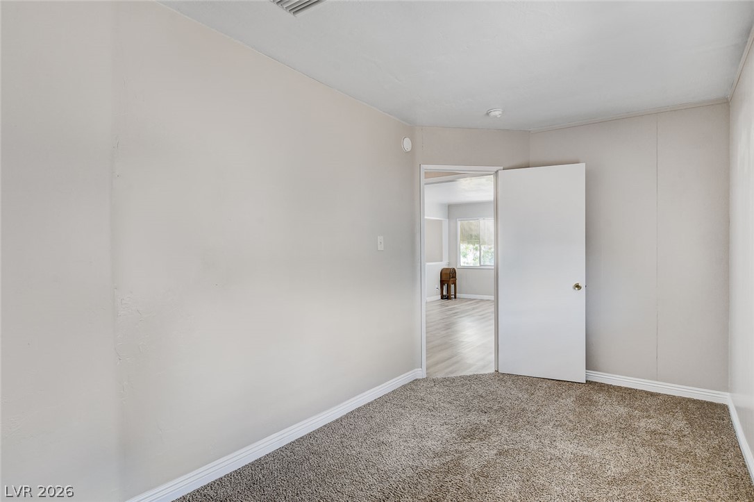 214 West Victory Road Henderson, NV 89015 - Photo 21 of 33 A well-maintained interior offers carpeted flooring leading to a view of the adjacent room.