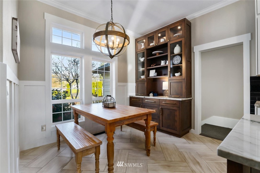4458 Preston-Fall City Road Southeast Fall City, WA 98024 - Photo 11 of 40 a view of a dining room and livingroom with furniture wooden floor a rug a potted plant and a chandelier