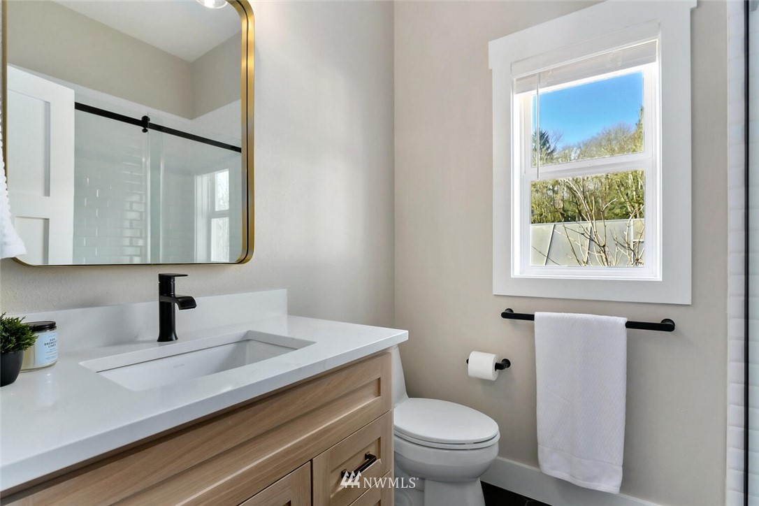 4458 Preston-Fall City Road Southeast Fall City, WA 98024 - Photo 25 of 40 a bathroom with a toilet sink and mirror
