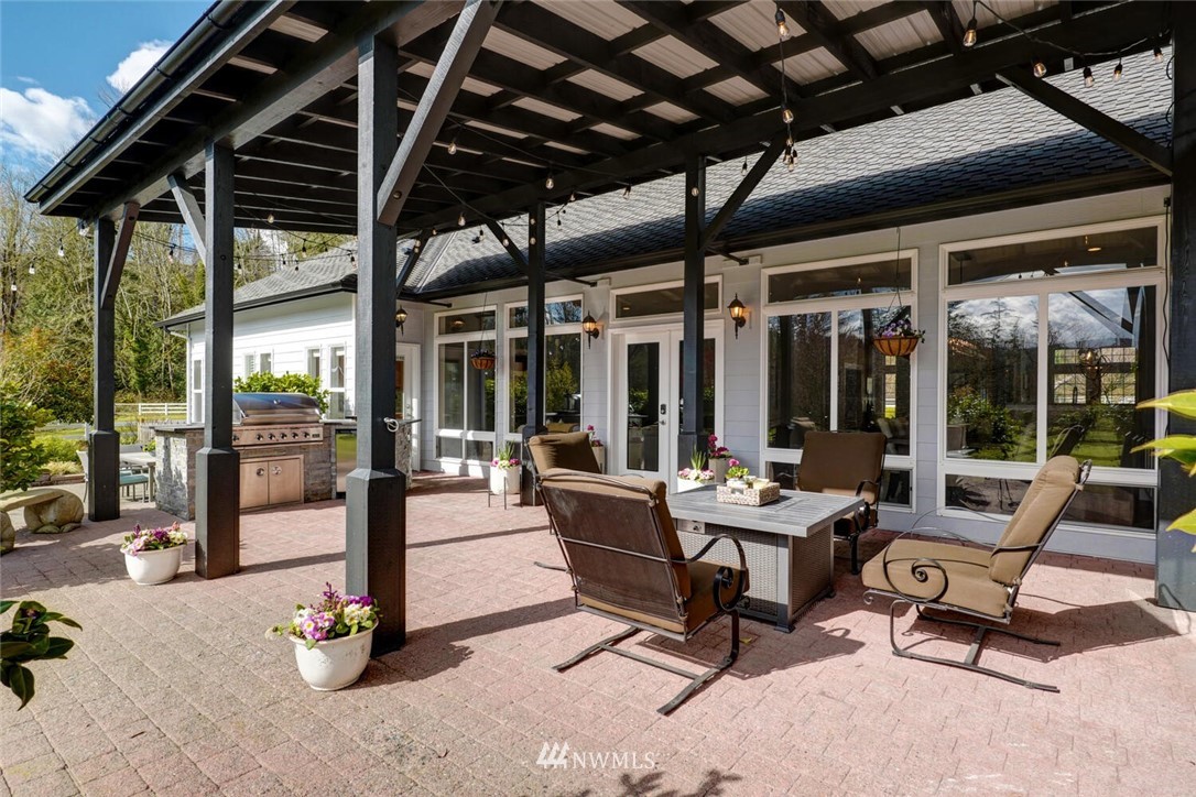 4458 Preston-Fall City Road Southeast Fall City, WA 98024 - Photo 27 of 40 a living room with patio furniture and a view of the ocean