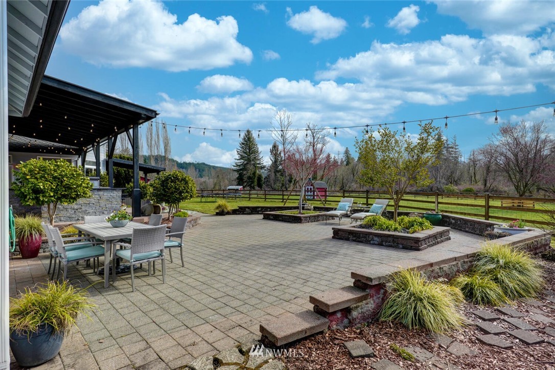 4458 Preston-Fall City Road Southeast Fall City, WA 98024 - Photo 29 of 40 a view of a swimming pool with lawn chairs and a fire pit