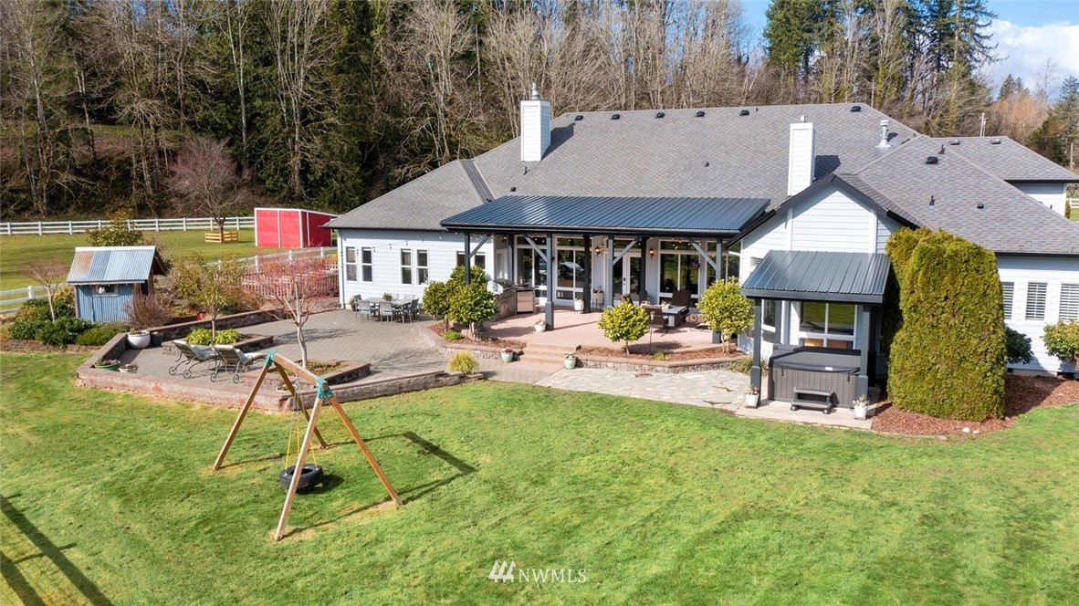 4458 Preston-Fall City Road Southeast Fall City, WA 98024 - Photo 30 of 40 a view of a patio with table and chairs under an umbrella