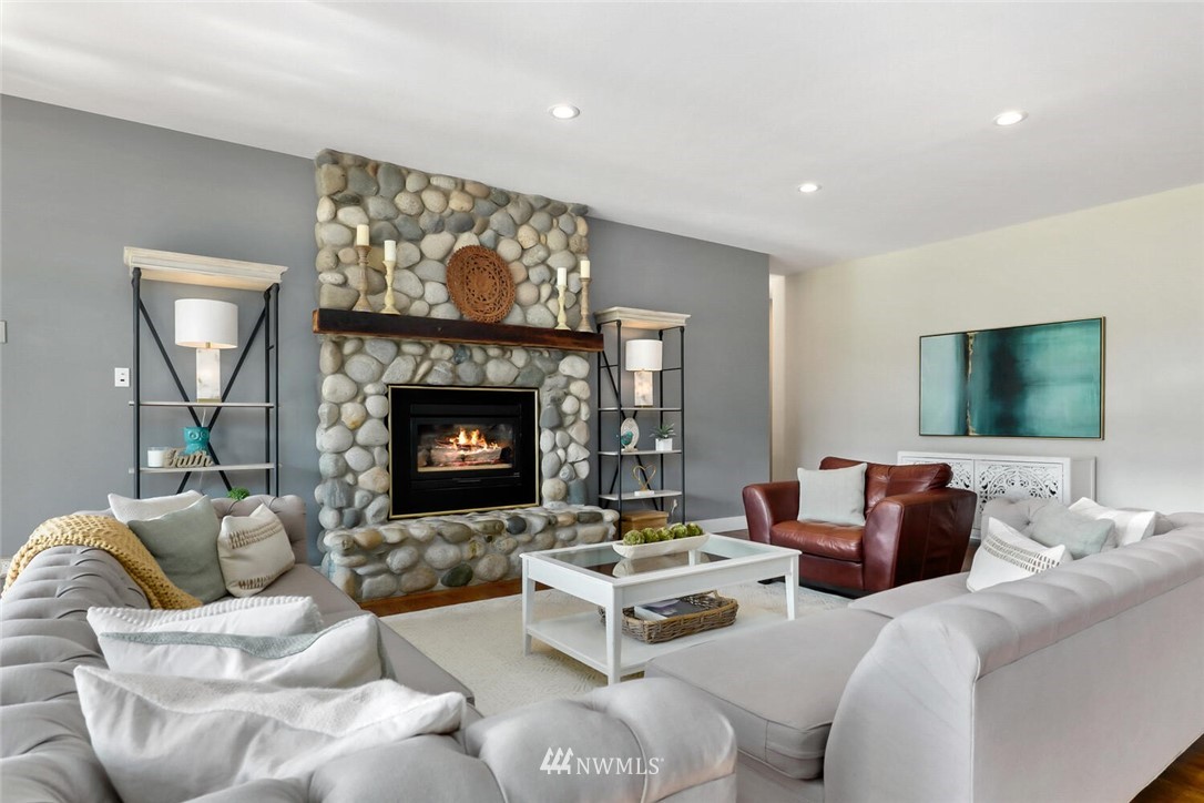 4458 Preston-Fall City Road Southeast Fall City, WA 98024 - Photo 7 of 40 a living room with furniture a flat screen tv and a fireplace