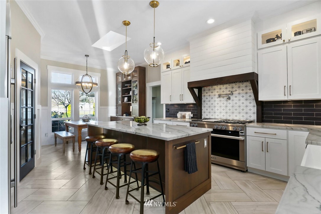 4458 Preston-Fall City Road Southeast Fall City, WA 98024 - Photo 8 of 40 a kitchen with cabinets a sink dining table and chairs