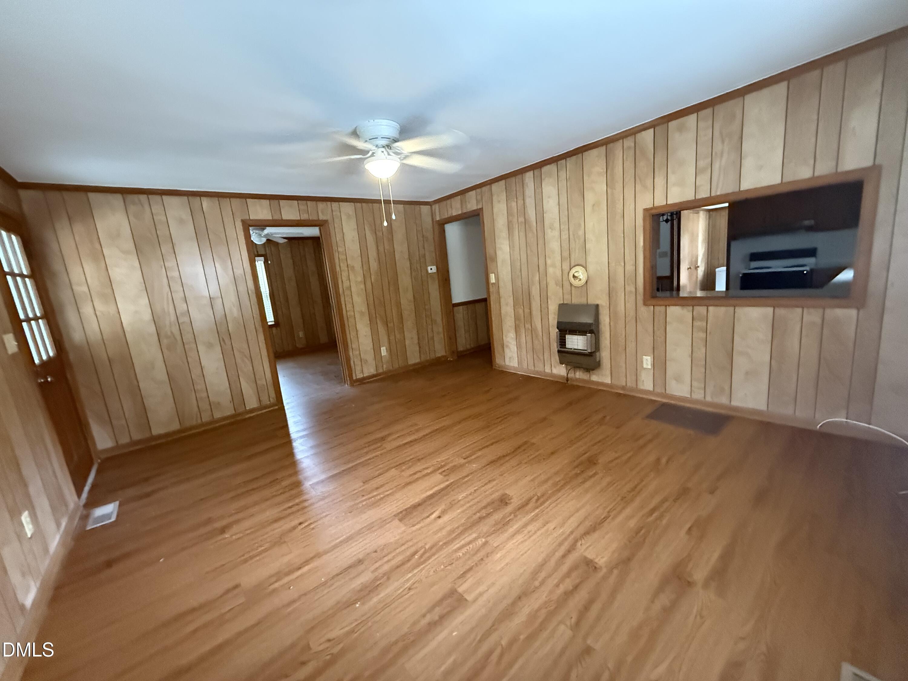 2005 Flat Rock Church Road Youngsville, NC 27596 - Photo 11 of 21 a view of a livingroom with wooden floor and a ceiling fan
