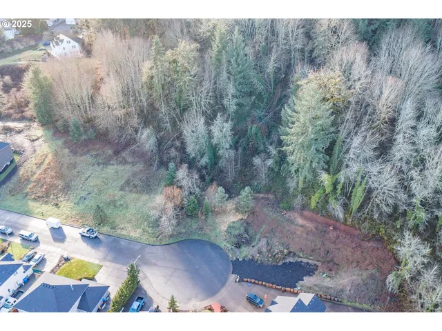 a view of a yard with wooden fence