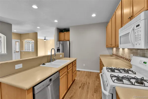 a kitchen with sink a stove and a refrigerator