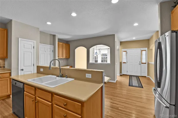 a spacious bathroom with a sink a toilet and a mirror