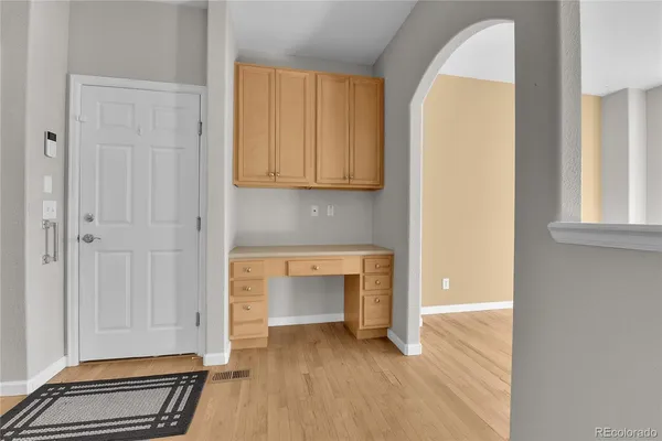 a view of a room with wooden floor and a fireplace