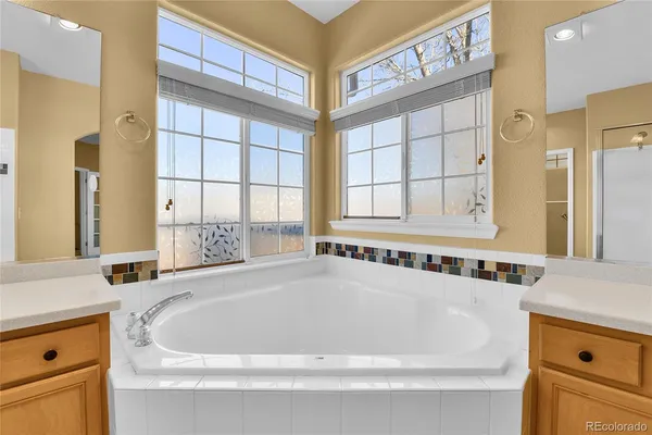 a bathroom with bathtub and a window