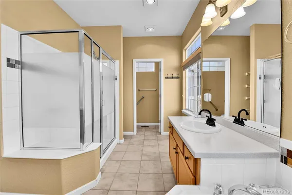 a bathroom with a sink a mirror and a shower