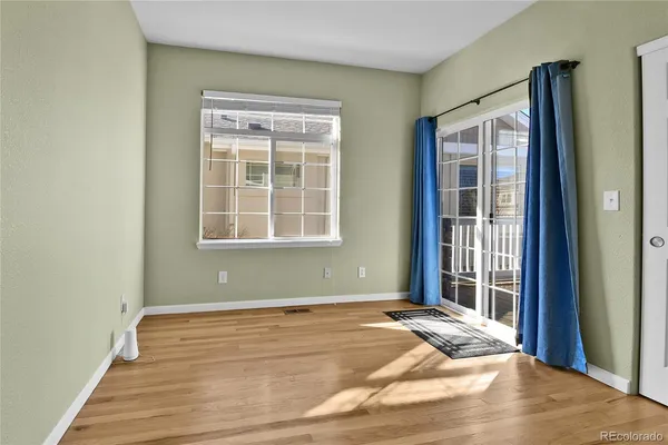 a view of a room with wooden floor and windows