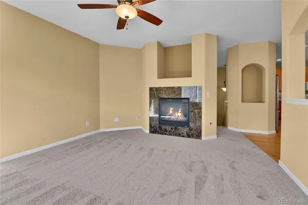 a view of an empty room with a fireplace