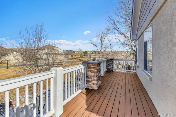 a view of a balcony with wooden floor and outdoor space