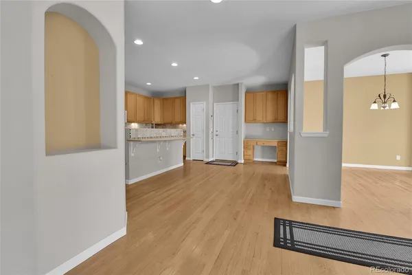 a kitchen with a refrigerator and a stove top oven