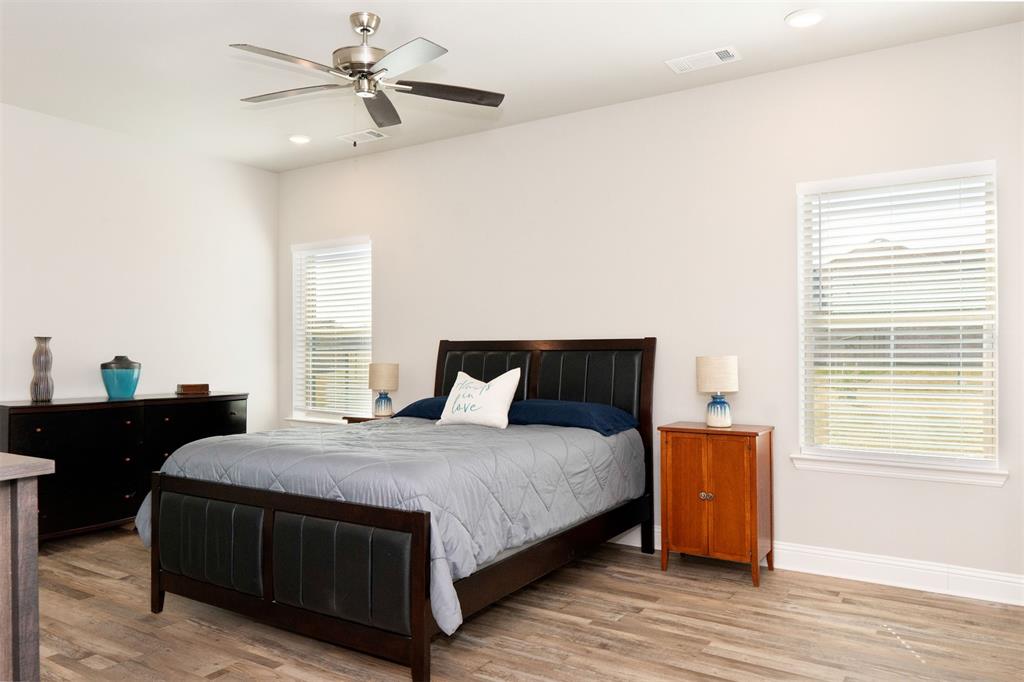 849 County Road 4764 Boyd, TX 76023 - Photo 37 of 40 a bedroom with a bed and wooden floor