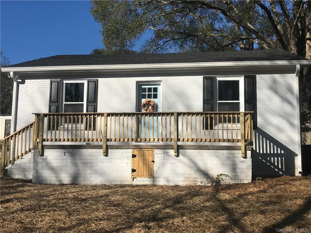 a view of a house with a wooden deck