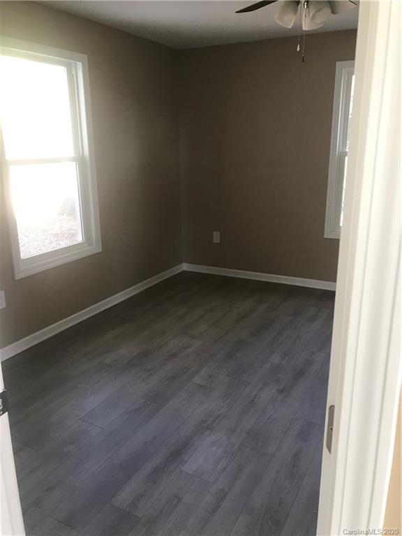 1507 Riley Street Albemarle, NC 28001 - Photo 13 of 26 an empty room with wooden floor and windows