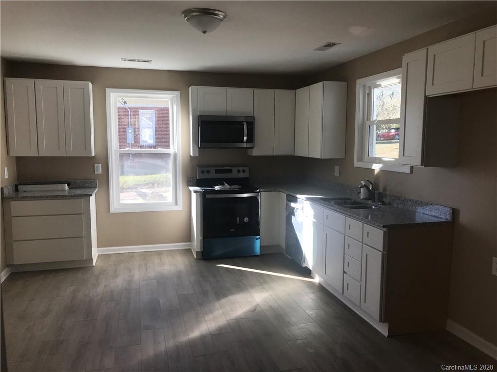 1507 Riley Street Albemarle, NC 28001 - Photo 14 of 26 a kitchen with granite countertop a refrigerator stove and sink