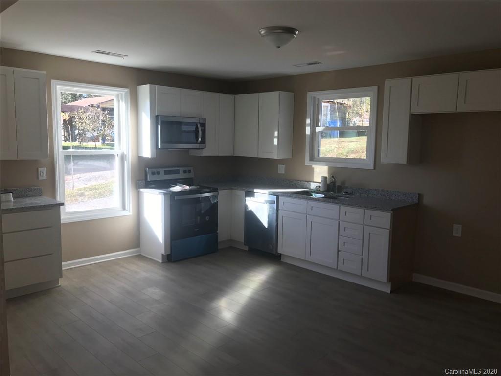 1507 Riley Street Albemarle, NC 28001 - Photo 15 of 26 a kitchen with stainless steel appliances granite countertop a sink stove and refrigerator