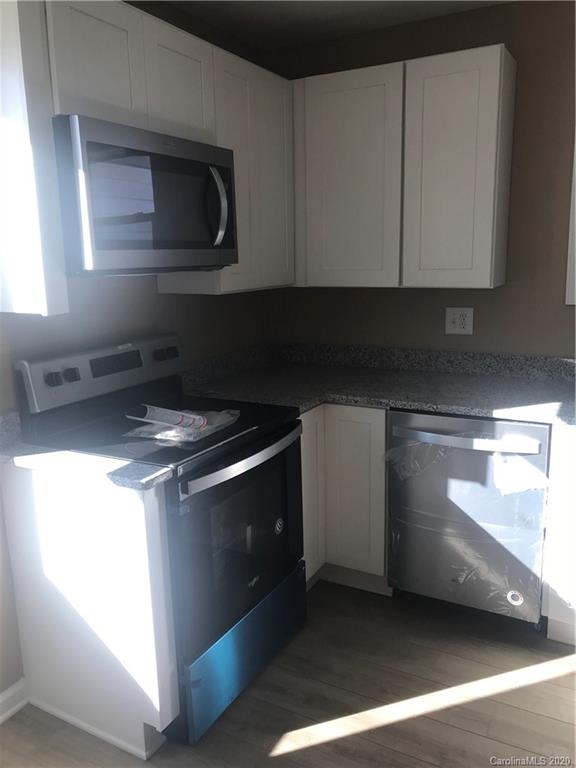 1507 Riley Street Albemarle, NC 28001 - Photo 17 of 26 a kitchen with a stove and a microwave