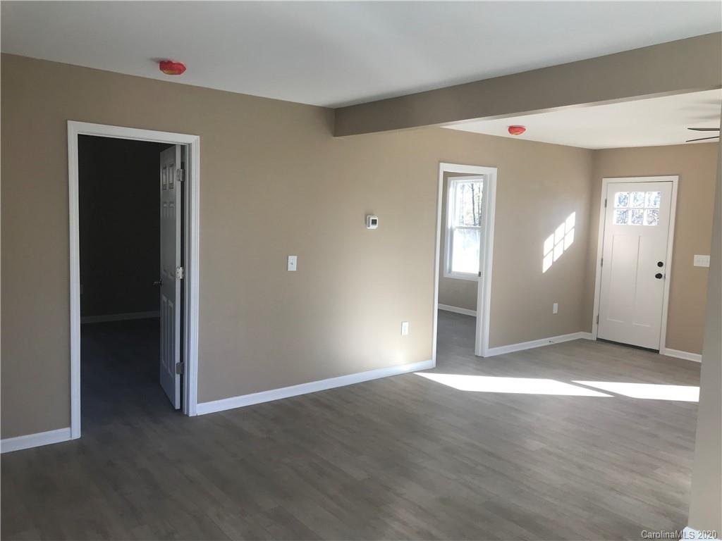 1507 Riley Street Albemarle, NC 28001 - Photo 7 of 26 an empty room with wooden floor and windows