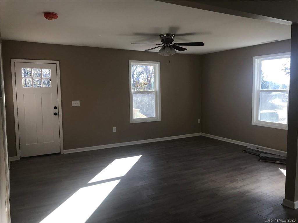 1507 Riley Street Albemarle, NC 28001 - Photo 9 of 26 a view of an empty room with wooden floor and a window
