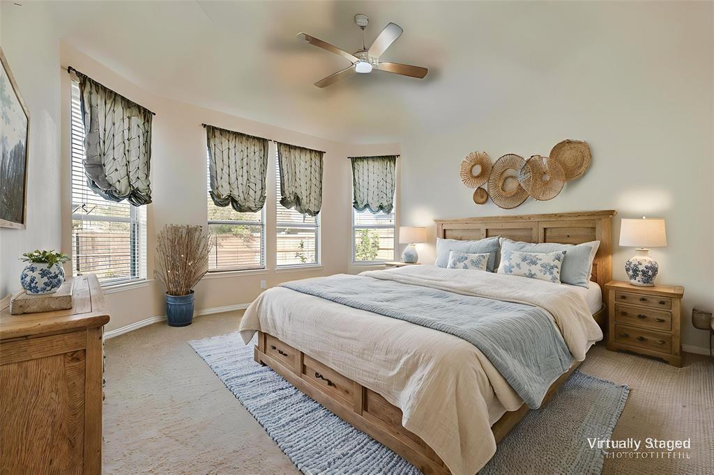 1010 Newington Circle Forney, TX 75126 - Photo 12 of 26 a bedroom with a bed and dresser with mirror