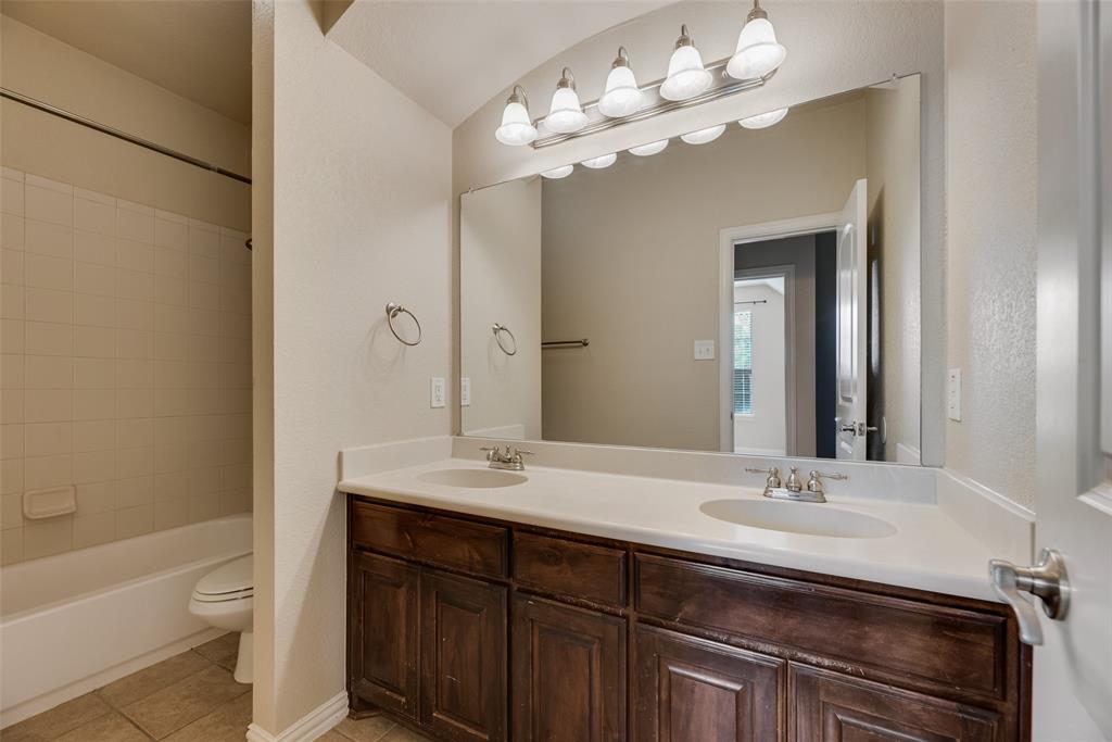 1010 Newington Circle Forney, TX 75126 - Photo 25 of 26 a bathroom with a sink a toilet and a bathtub