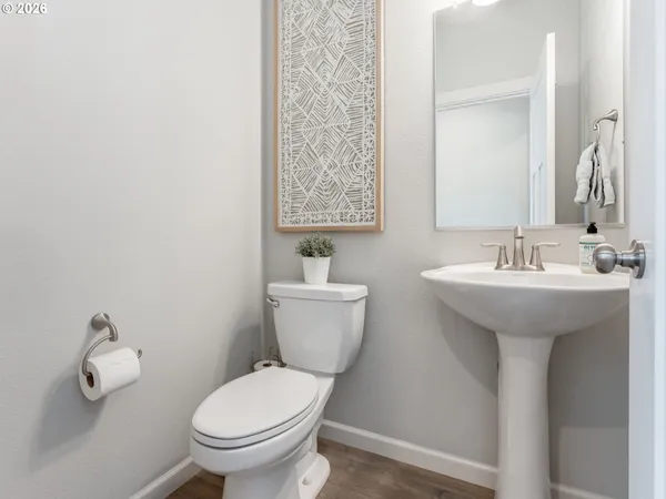a bathroom with a sink toilet and a mirror