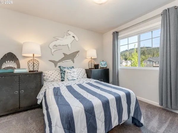 a bedroom with a bed and a dresser in it