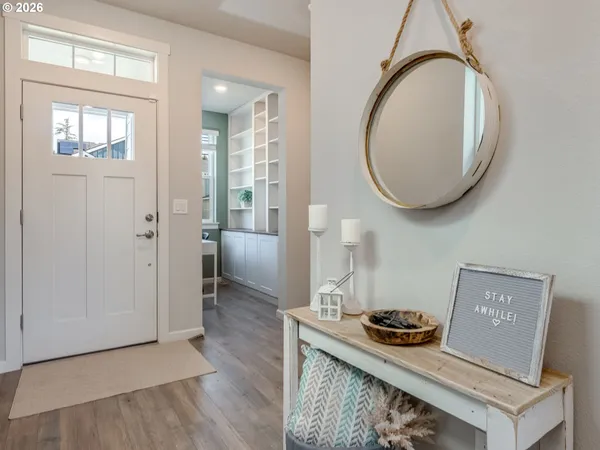 an entryway with wooden floor and a sink