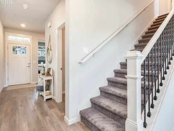 a view of entryway and hall with wooden floor