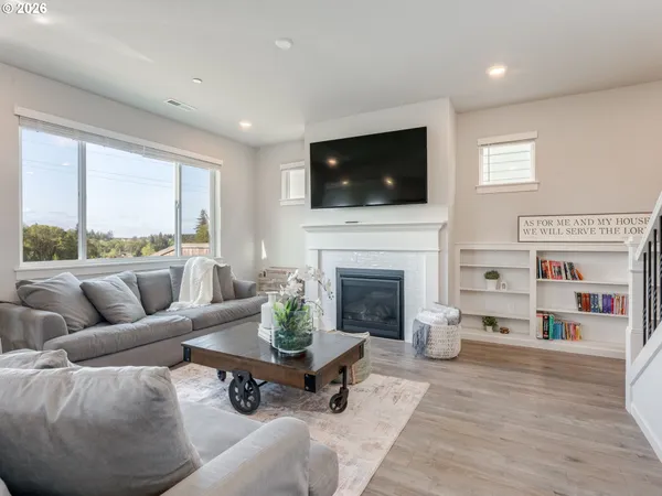 a living room with furniture fireplace and flat screen tv