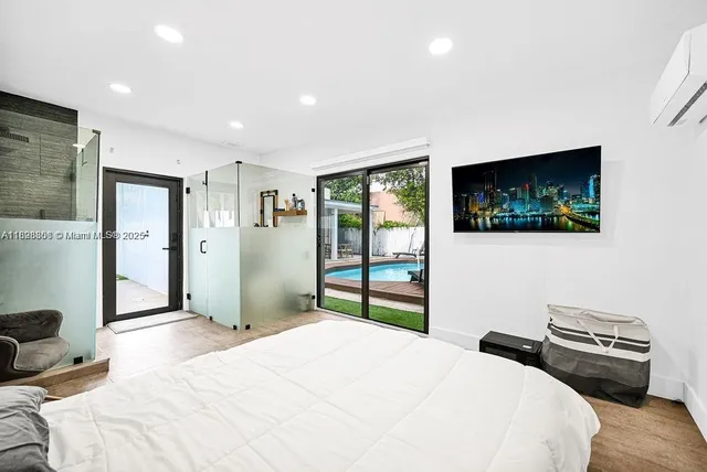 a bedroom with a bed and a flat screen tv