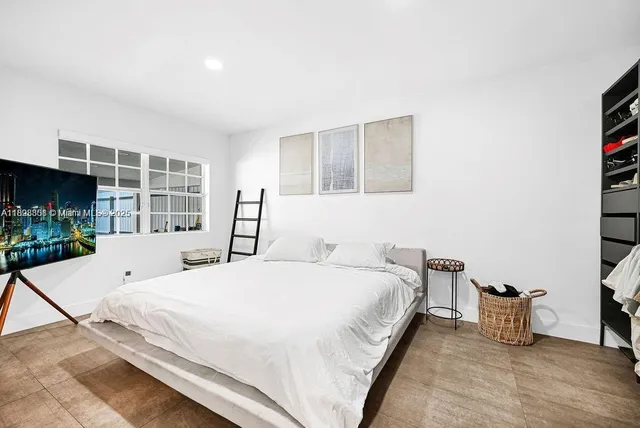 a bed room with a bed and a large window