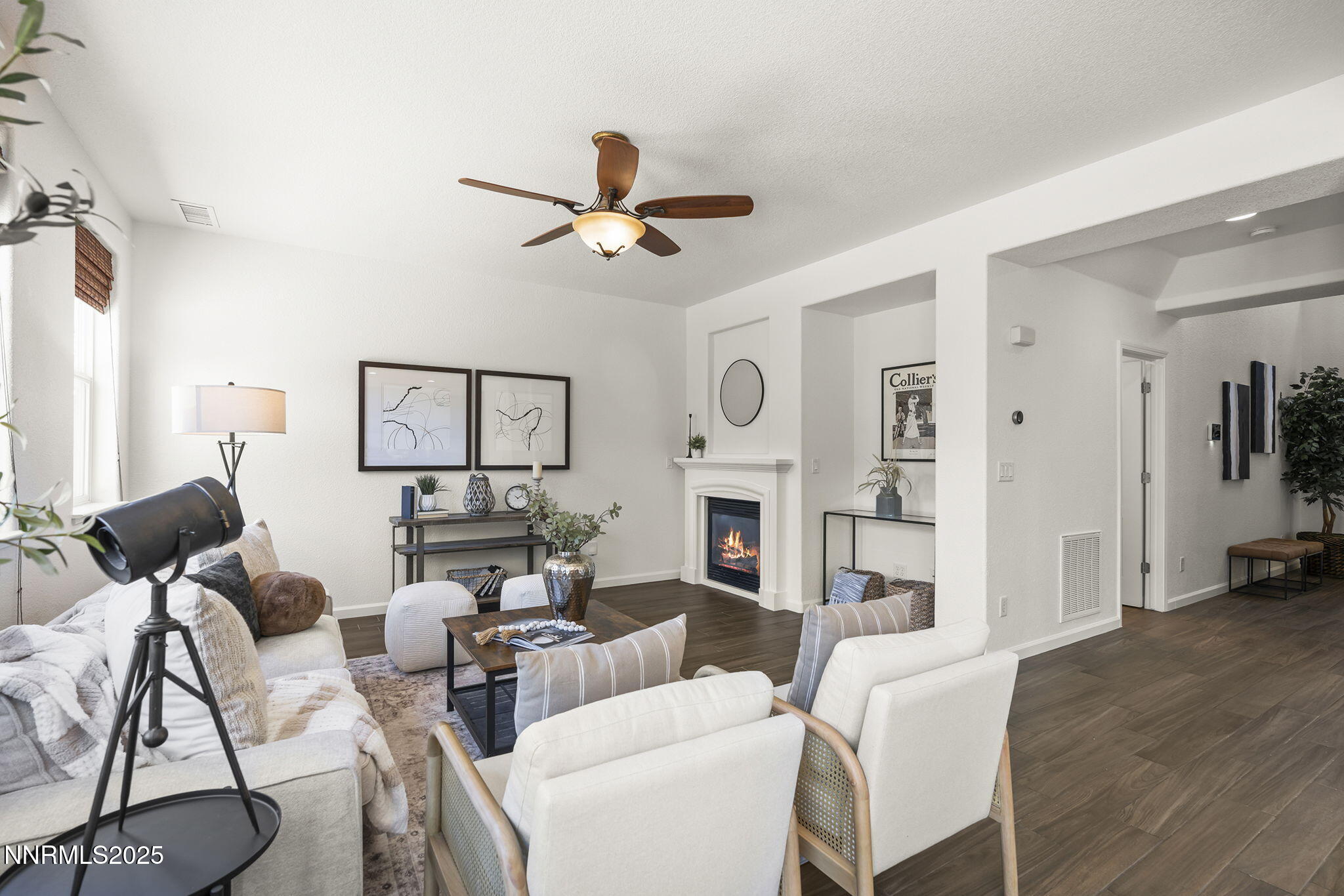 11135 Messina Way Reno, NV 89521 - Photo 16 of 31 a living room with furniture a fireplace and a view of kitchen