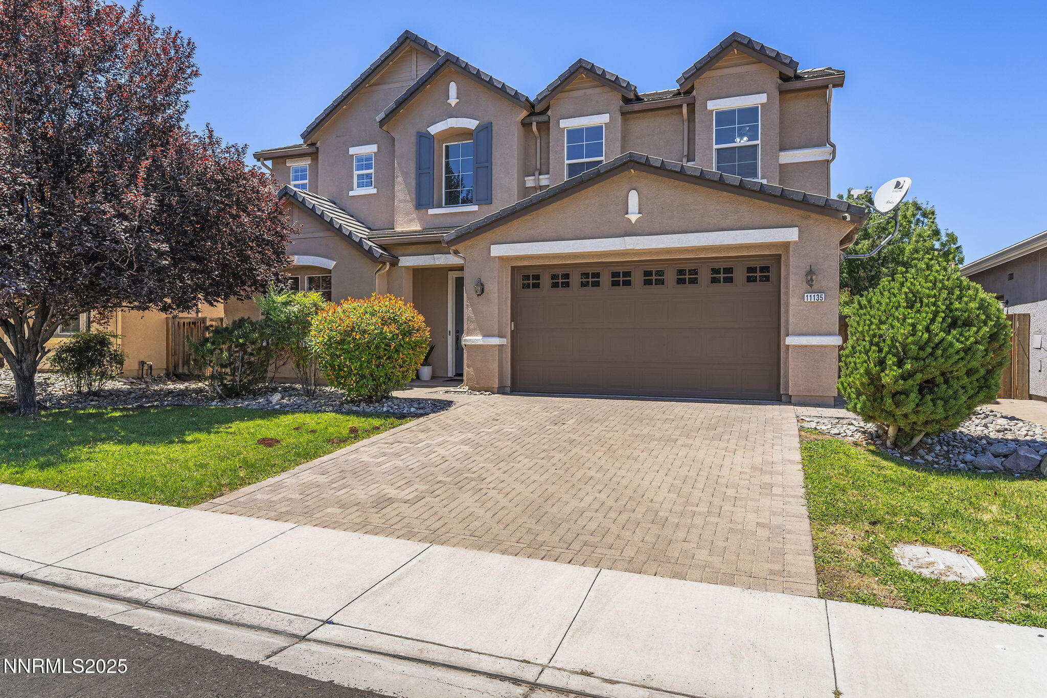 11135 Messina Way Reno, NV 89521 - Photo 2 of 31 a front view of a house with a yard and garage