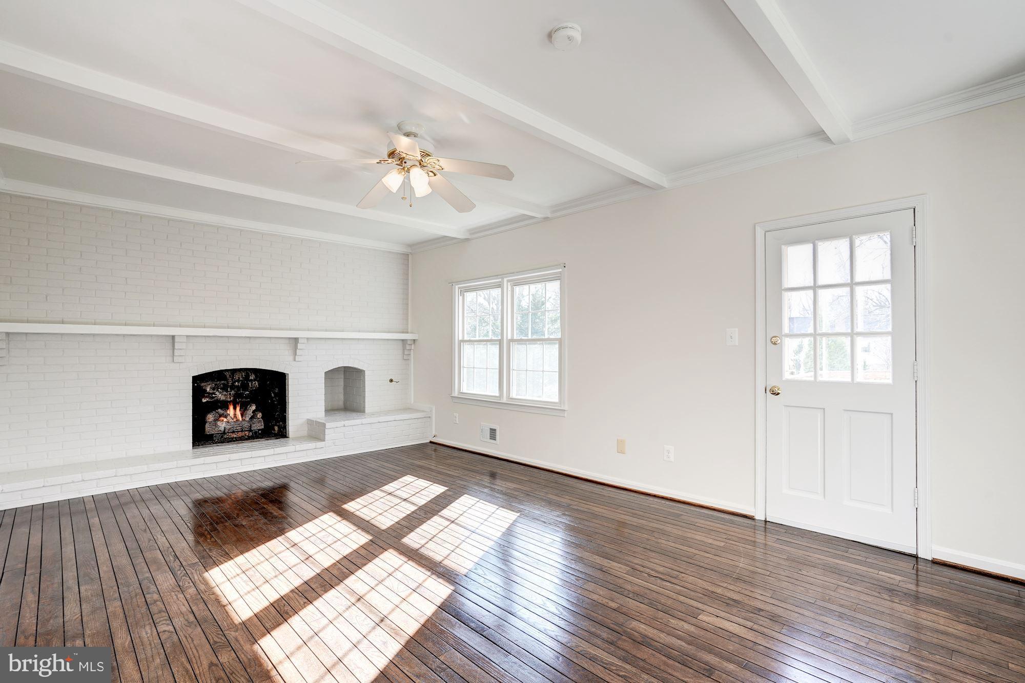 7915 Foxhound Road McLean, VA 22102 - Photo 8 of 19 Family Room w/ Gas Fireplace & Access to Deck