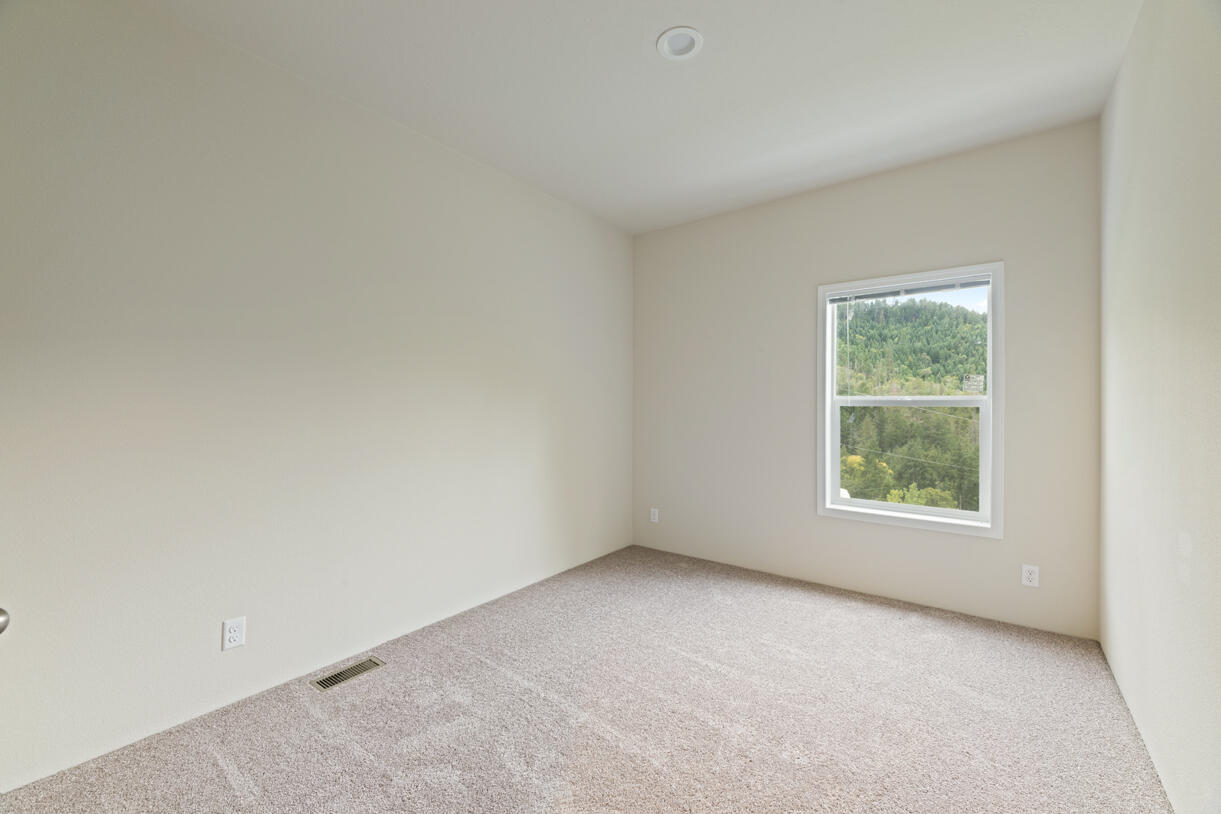 5572 Jumpoff Joe Creek Road Grants Pass, OR 97526 - Photo 17 of 38 an empty room with windows