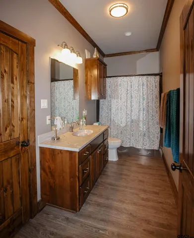 a bathroom with a double vanity sink a large mirror and shower