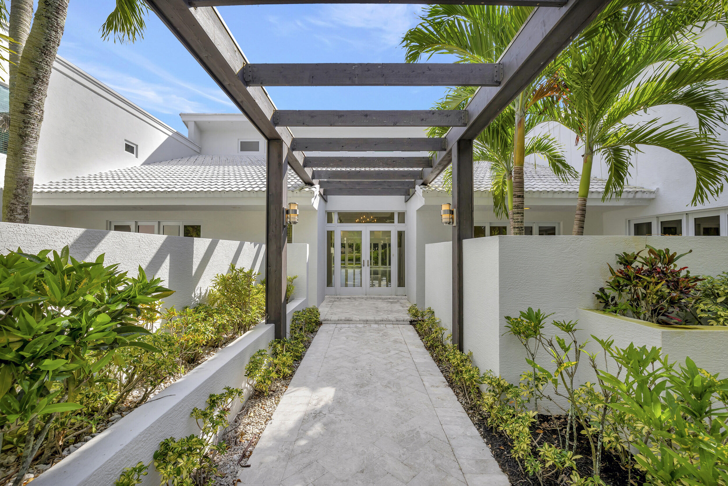 355 Oakview Drive Delray Beach, FL 33445 - Photo 2 of 92 a front view of a house with a garden
