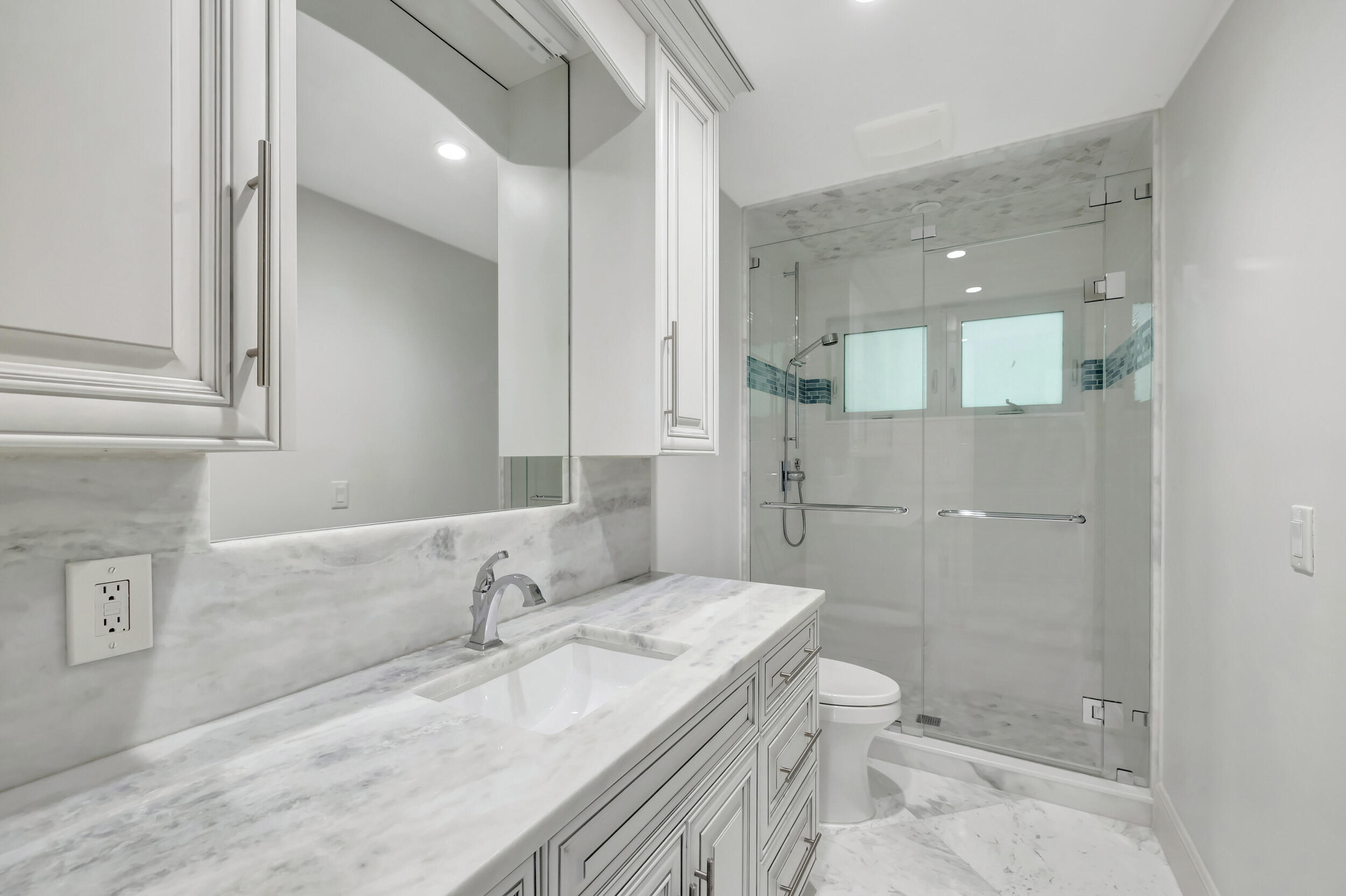 355 Oakview Drive Delray Beach, FL 33445 - Photo 42 of 92 a bathroom with a granite countertop sink a toilet and shower