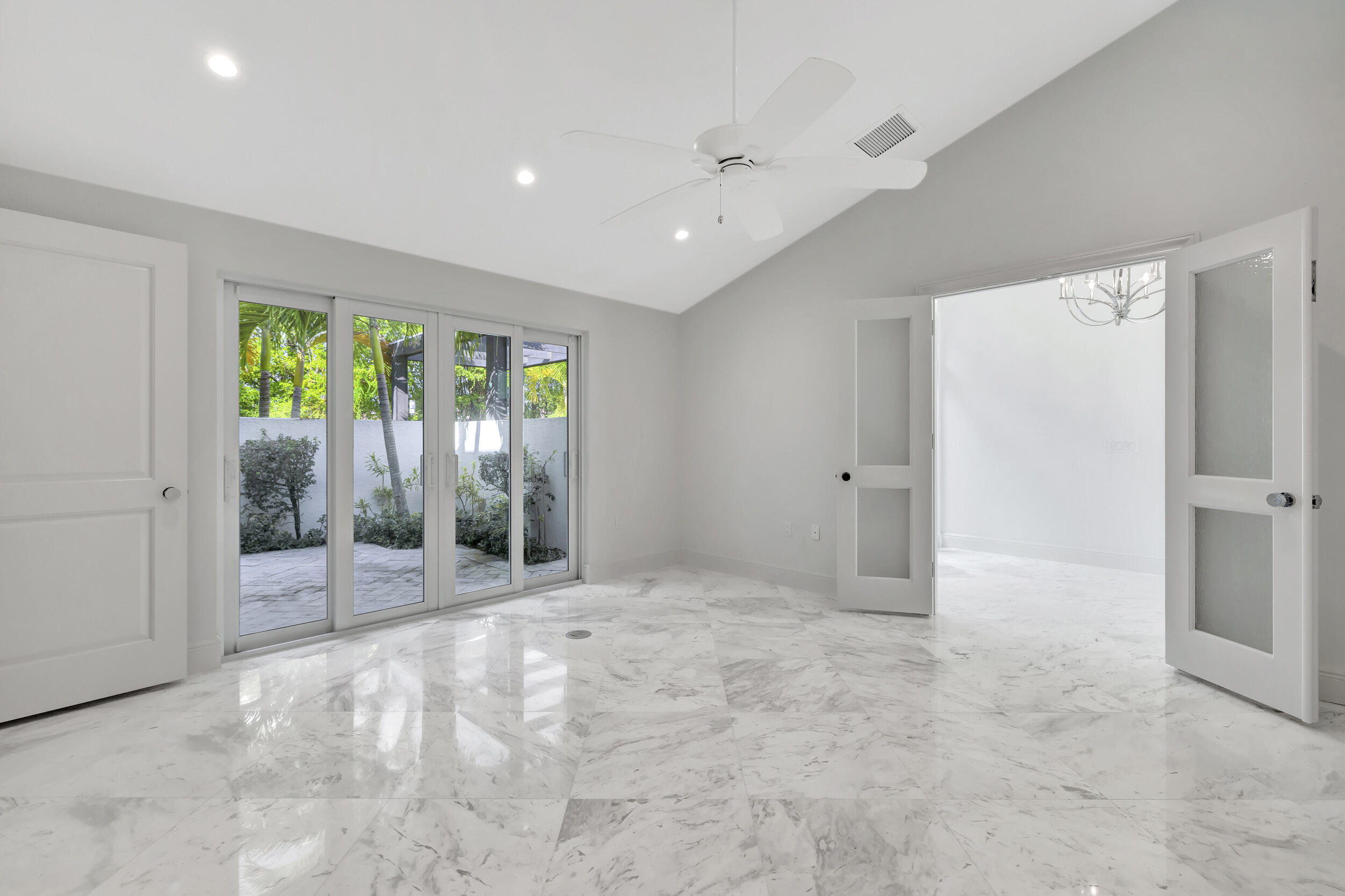 355 Oakview Drive Delray Beach, FL 33445 - Photo 53 of 92 a view of an empty room with wooden floor and a sliding door
